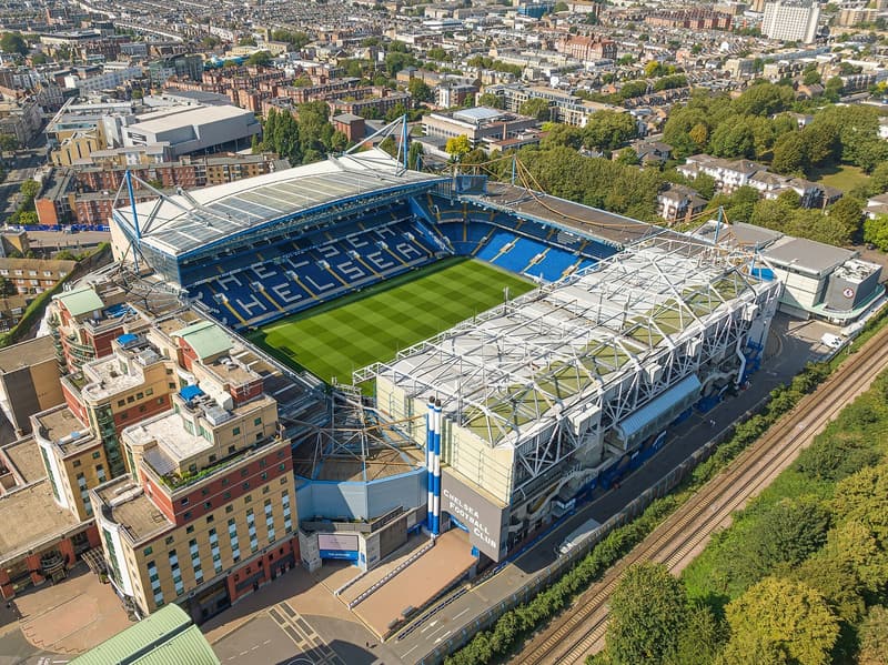 Football players competing during a Premier League match at Stamford Bridge.